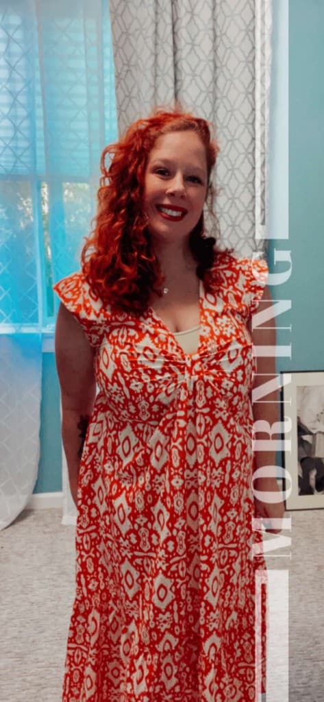 Miss Gleason smiling in a red patterned dress
